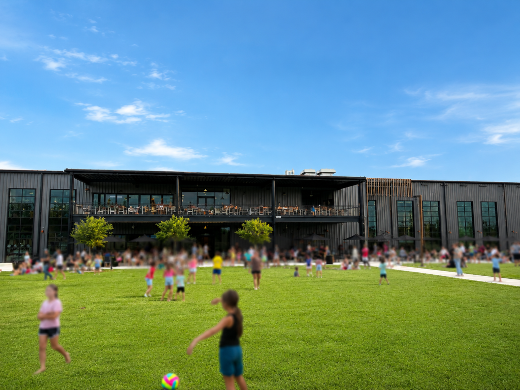 Family-friendly lawn at Crooked Can Brewing Company in Minneola, Florida, with visitors enjoying the outdoor green space.